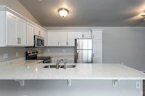 Jackson apartment for rent - a kitchen with a white counter top and a refrigerator