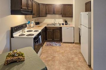Appleton apartment for rent - A kitchen with a white stove and a white refrigerator.