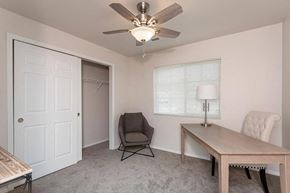 Waterford apartment for rent - A room with a ceiling fan, a table, a chair, and a window with blinds.