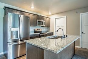 Holmen apartment for rent - a kitchen with stainless steel appliances and a granite counter top