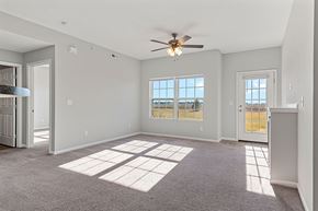 Chatham apartment for rent - A spacious room with a ceiling fan and large windows.