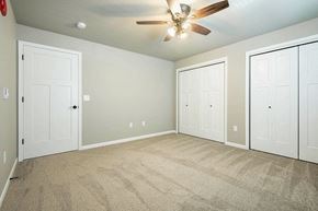 Onalaska apartment for rent - an empty bedroom with three doors and a ceiling fan