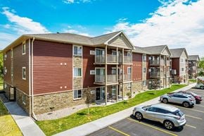 Holmen apartment for rent - an apartment building with cars parked in a parking lot