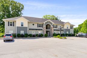Knightstown apartment for rent - A large building with a parking lot in front of it.