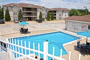 Quincy apartment for rent - a swimming pool with a white fence around it