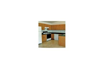 Neenah apartment for rent - a kitchen with wooden cabinets and a white stove