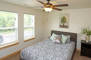 Waukesha apartment for rent - a bedroom with a bed and a ceiling fan