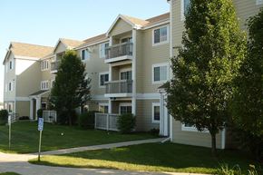 Carroll apartment for rent - an apartment building with a lawn and trees