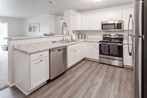 Horicon apartment for rent - a kitchen with white cabinets and stainless steel appliances