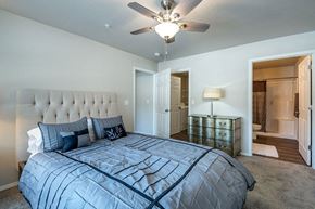 Oshkosh apartment for rent - a bedroom with a large bed and a ceiling fan