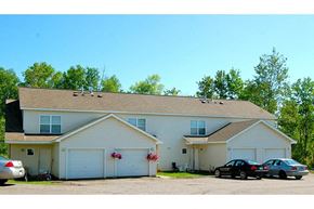 Duluth apartment for rent - A two-story house with a garage and a car parked in front.