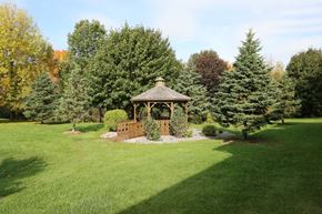 Appleton apartment for rent - A gazebo sits in the middle of a lush green lawn.