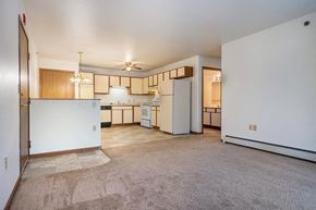 Stevens Point apartment for rent - A kitchen with white appliances and wooden cabinets.