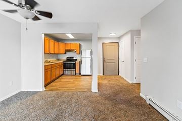 Port Huron apartment for rent - A kitchen with orange cabinets and a fan.
