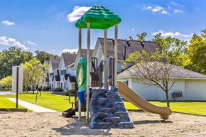 Waseca townhouse for rent - a playground with a slide and a umbrella