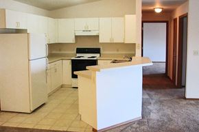 Manitowoc apartment for rent - an empty kitchen with a stove and a refrigerator