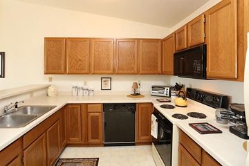 Neenah apartment for rent - a kitchen with a stove top oven and a sink