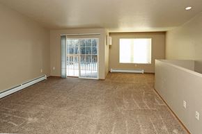 Rhinelander apartment for rent - an empty living room with a sliding glass door