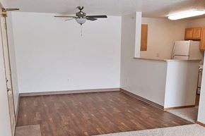 Ottumwa apartment for rent - an empty room with a white wall and a ceiling fan