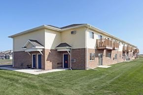 Little Chute apartment for rent - a brick building with a porch and a lawn