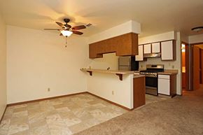 Elkhorn apartment for rent - an empty living room with a kitchen and a ceiling fan