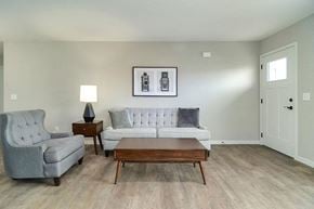 Hugo apartment for rent - a living room with a couch and a table