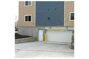 Viroqua apartment for rent - a house with a garage door and a building