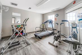Port Huron apartment for rent - A gym with a variety of equipment including a treadmill, a stationary bike, and a rowing machine.