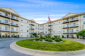 Port Huron apartment for rent - Apartment complex with a flag on the building.