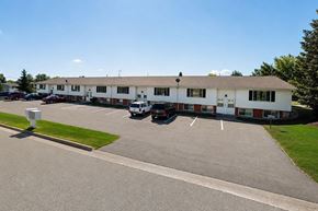 Sturgeon Bay apartment for rent - A white building with a parking lot in front.