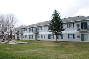 Albert Lea apartment for rent - a large white house with a yard in front of it