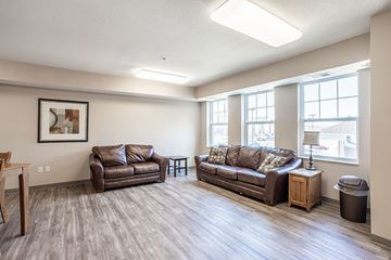 Ames apartment for rent - A living room with two couches and a wooden table.