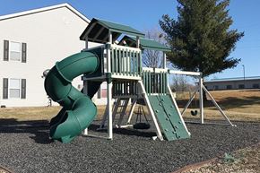 Marshalltown apartment for rent - A green and white playground slide in front of a house.