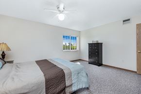 Le Claire apartment for rent - a bedroom with a bed and a ceiling fan