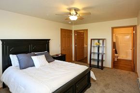 Kiel apartment for rent - a bedroom with a large bed and a ceiling fan