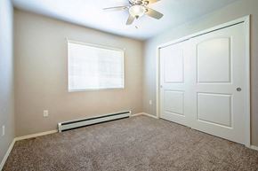 Portage apartment for rent - an empty room with a ceiling fan and a white door