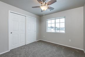 Jackson apartment for rent - an empty bedroom with a ceiling fan and a window
