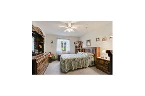 Marinette apartment for rent - a bedroom with a bed and dresser and a ceiling fan