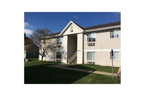 Winfield apartment for rent - a white house with a lawn and a sidewalk