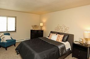 Beloit apartment for rent - a bedroom with a bed and a chair