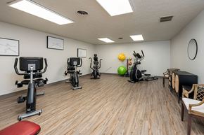 Terre Haute apartment for rent - A gym room with exercise equipment and a bench.