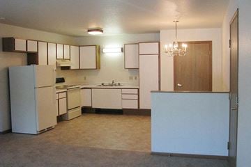 Sturgeon Bay apartment for rent - an empty kitchen with white appliances and white cabinets