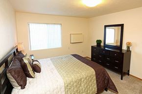 Appleton apartment for rent - a bedroom with a bed and a dresser