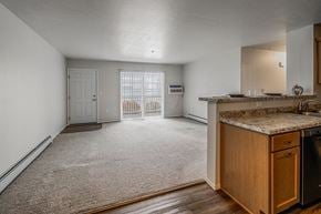 Plover apartment for rent - A kitchen area with a counter and a refrigerator.