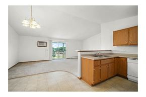 Marshfield apartment for rent - an empty kitchen and living room with a door to a balcony