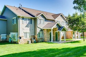 Kalamazoo apartment for rent - a row of houses with a yard and grass