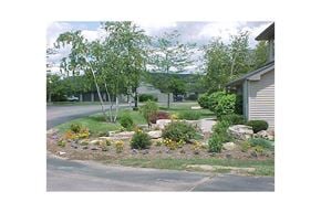 Lomira apartment for rent - a front yard with a flower garden and a house