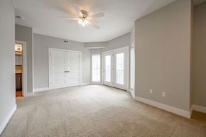 Hartford City apartment for rent - A spacious room with a ceiling fan and carpeted floor.