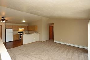 Rhinelander apartment for rent - an empty living room and kitchen with a white refrigerator