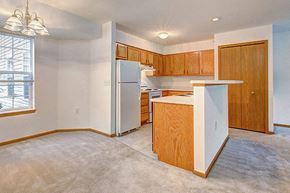 Portage apartment for rent - an empty kitchen with a refrigerator and a sink